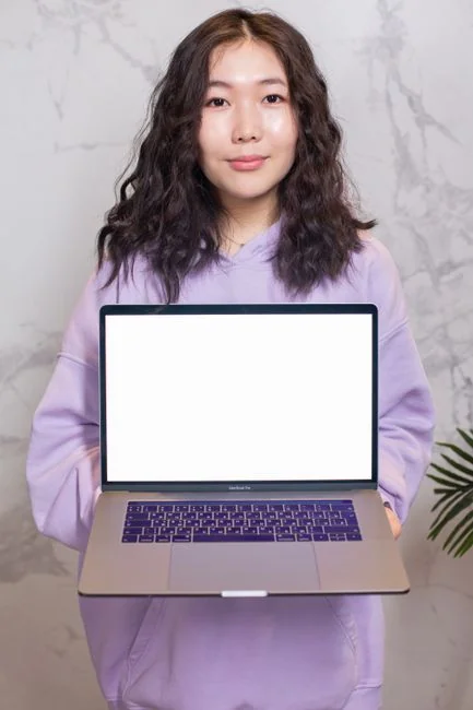 A clean and modern workspace featuring a laptop, tablet, smartphone, and monitor. Ideal for remote work and tech setups.